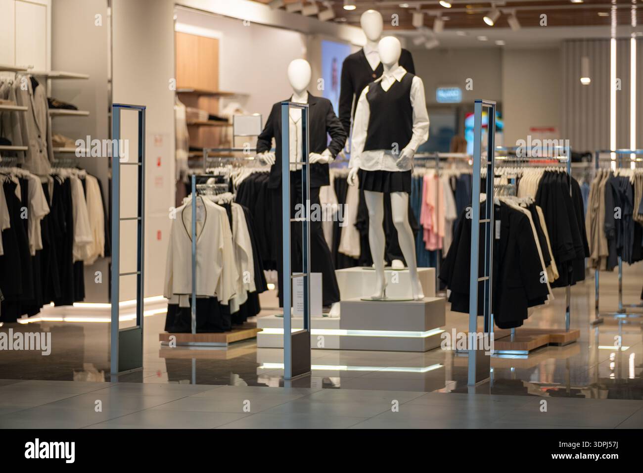 Modern clothing store interior with mannequins displaying formal attire ...