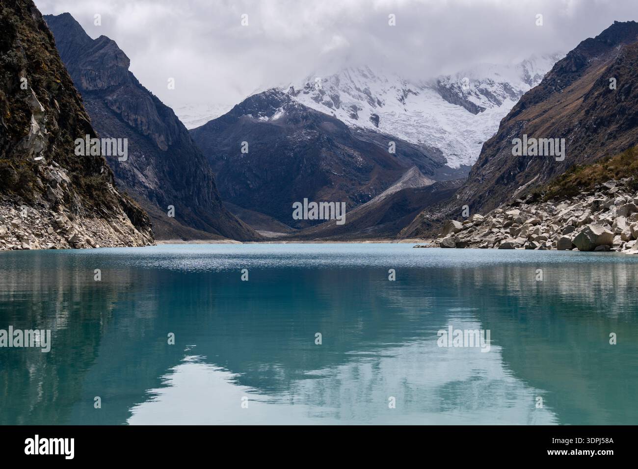 Huaraz, Peru: Reflection of the Laguna Paron and the iconic Piramied Peak in Cordillera Blanca, a famous mountain lake near Caraz in Peru Stock Photo