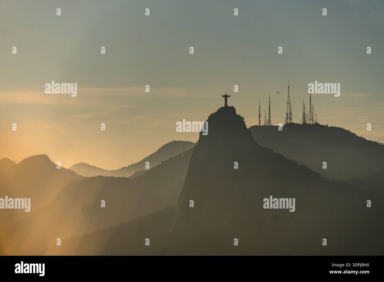 Rio de Janeiro, Brazil: Dramatic sunset over the iconic Christ the Redeemer statue in Rio de Janeiro in Brazil Stock Photo