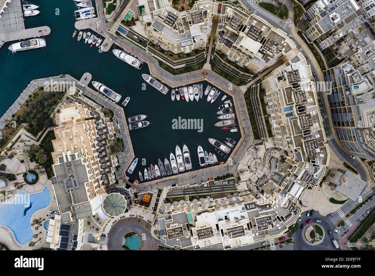 Aerial view of luxury yachts nestled in the vibrant, bustling Portomaso ...