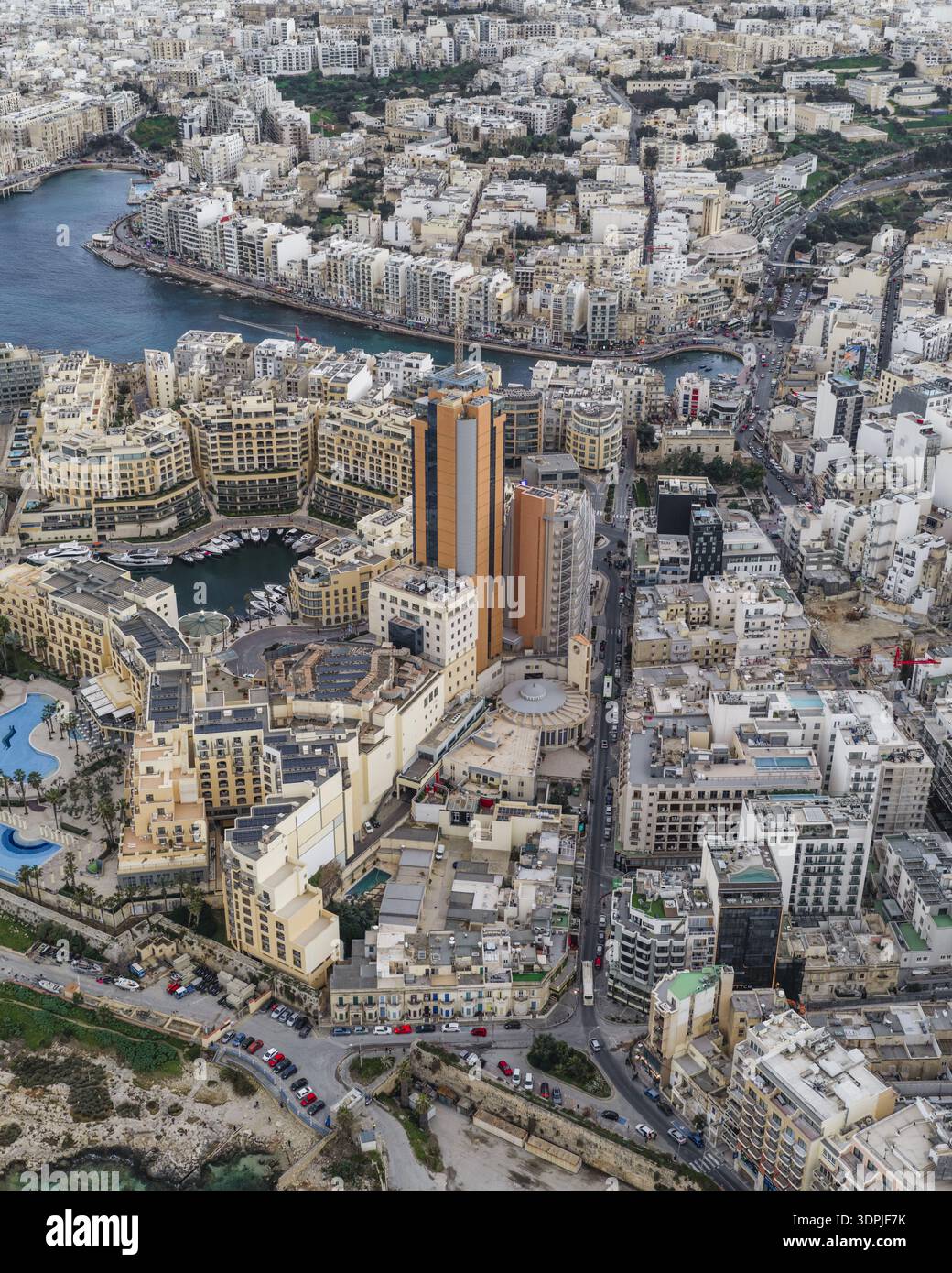 Aerial view of a densely packed cityscape meets the azure sea, with ...