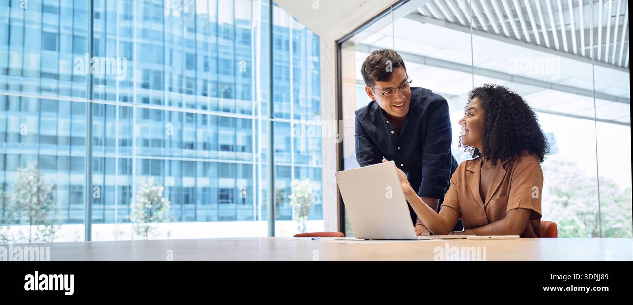 Busy manager consulting employee using laptop computer working in office. Stock Photo