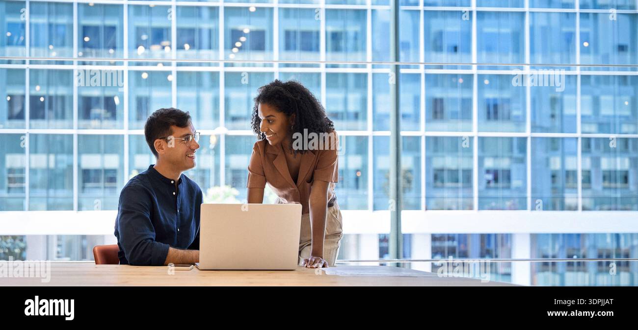 Busy happy diverse business team colleagues using laptop working in office. Stock Photo