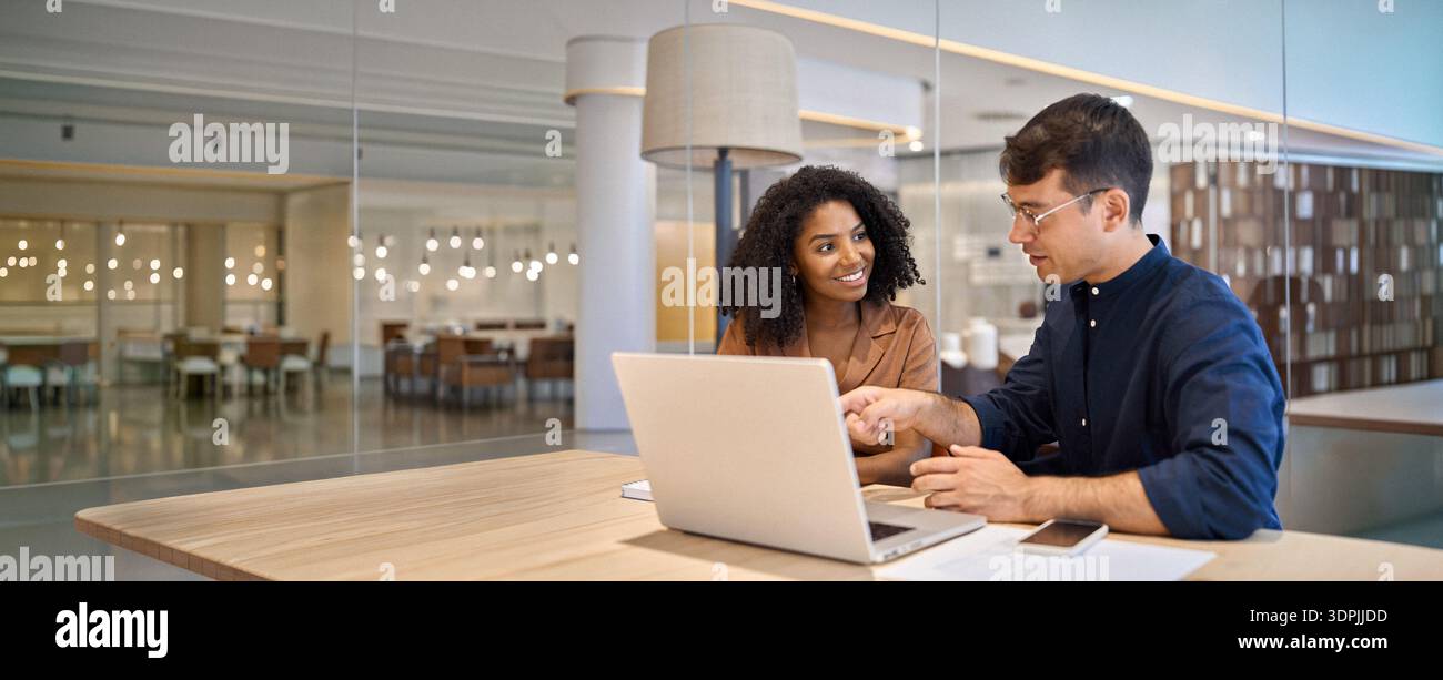 Diverse team professional employees working together on computer in office. Stock Photo
