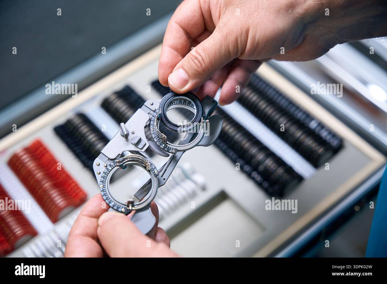 Ophthalmologist holding the trial lens frame from a set of other tools Stock Photo