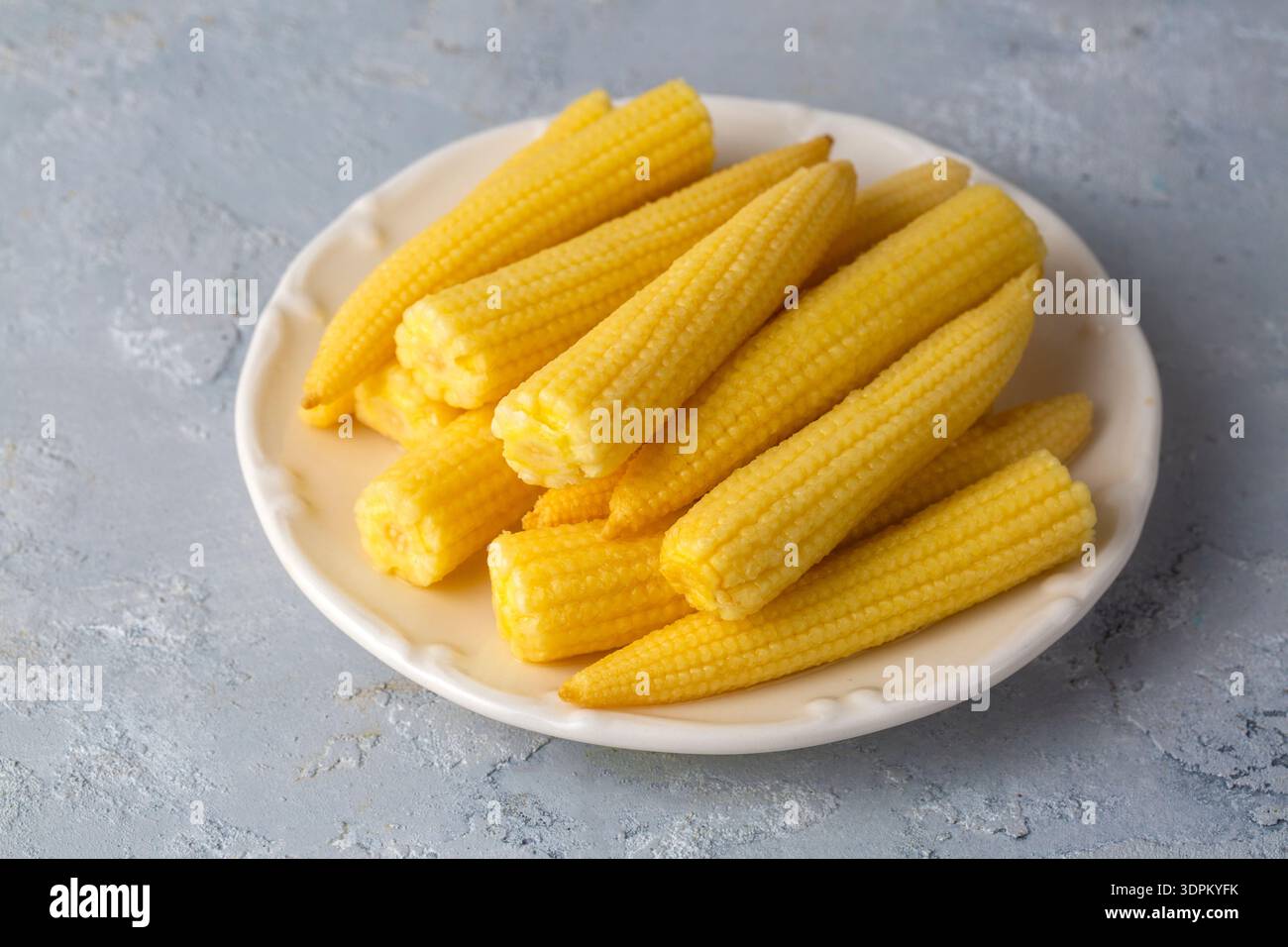 Pickled young baby corn cobs in jar Stock Photo