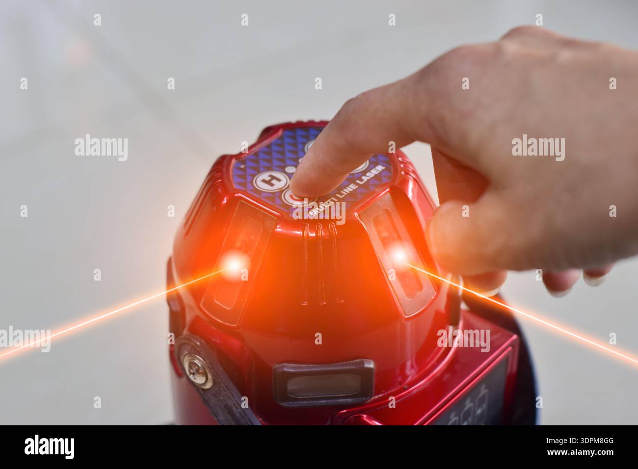The technician is using a laser level. Stock Photo