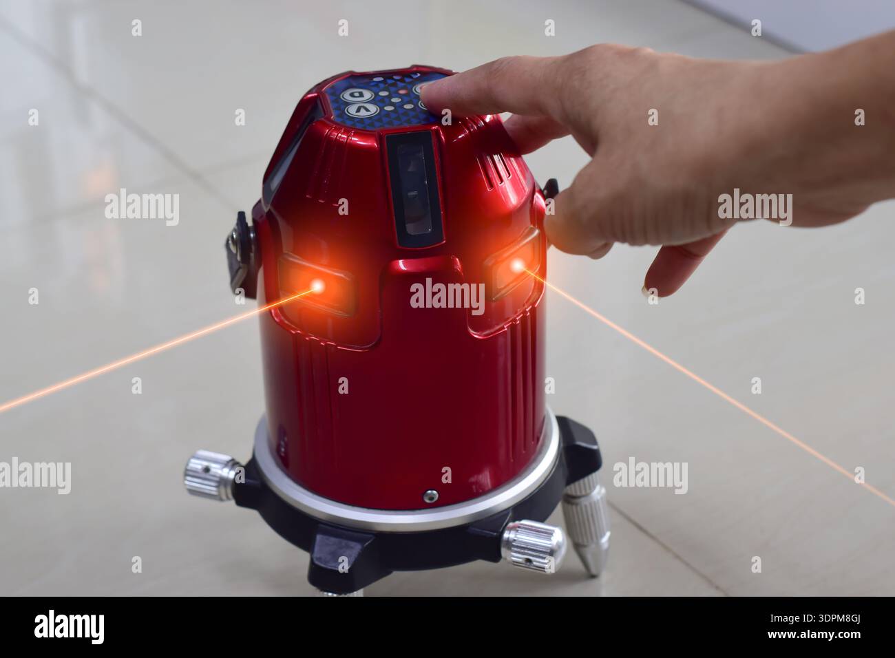 The technician is using a laser level. Stock Photo
