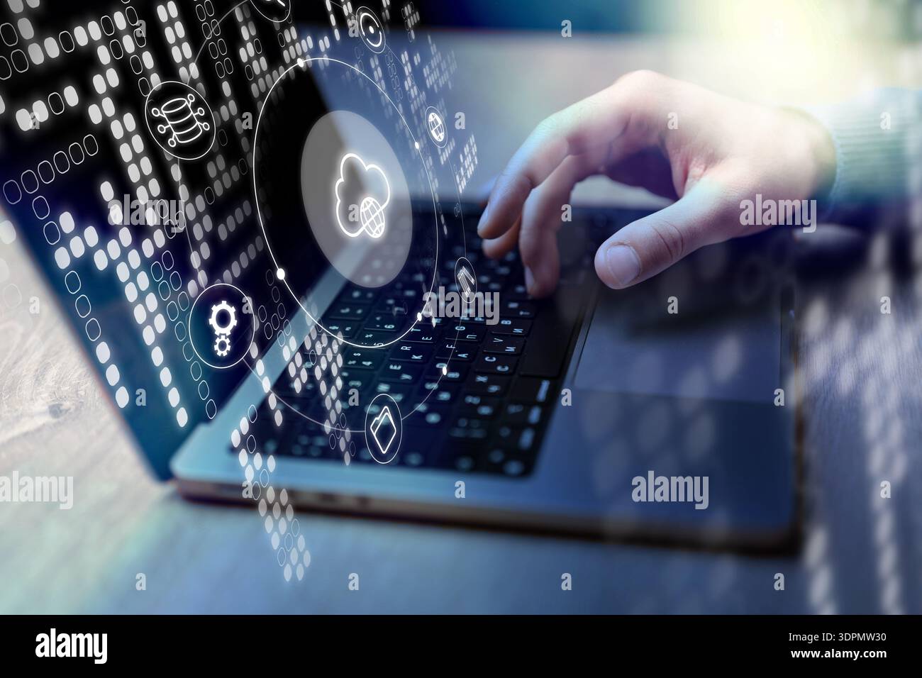 Person using a laptop with cloud computing icons in a modern workspace during day time Stock Photo