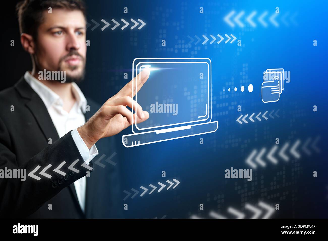 Man interacts with virtual screen showing computer and data transfer in modern office setting Stock Photo