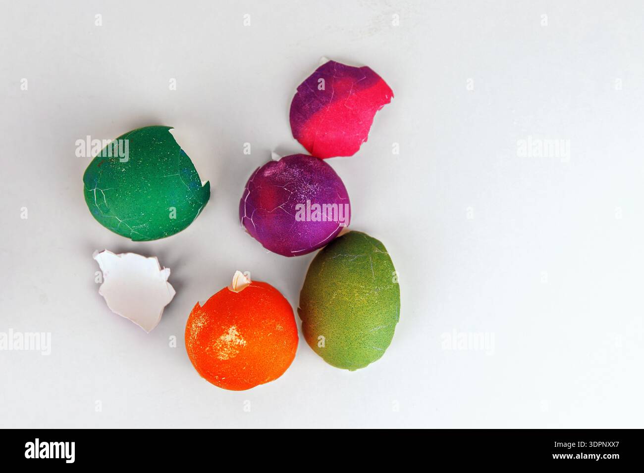 Colorful cracked easter egg shells on white background with copy space. Soft focus Stock Photo