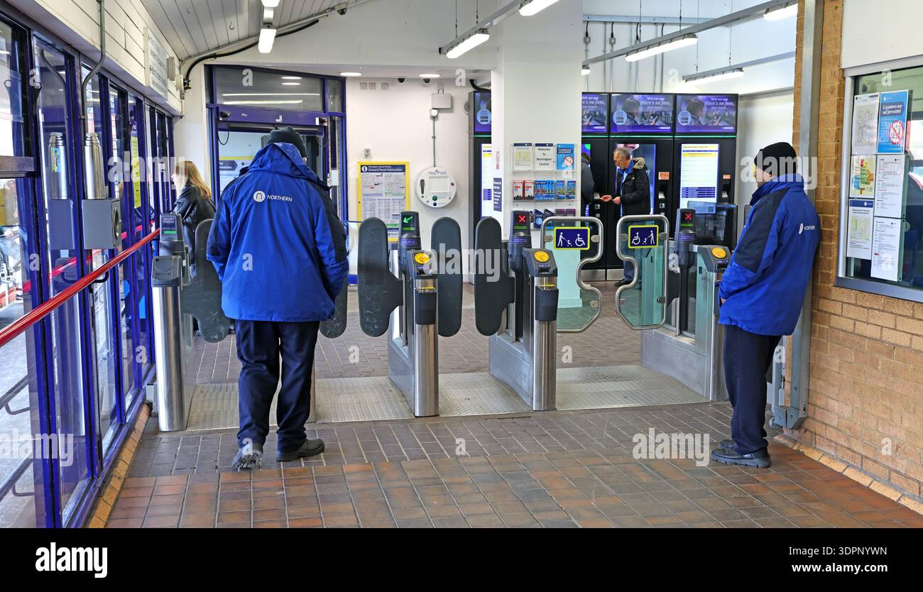 Northern Railway revenue protection officers at ticket barriers, Warrington Central railway station, Cheshire, England. Stock Photo