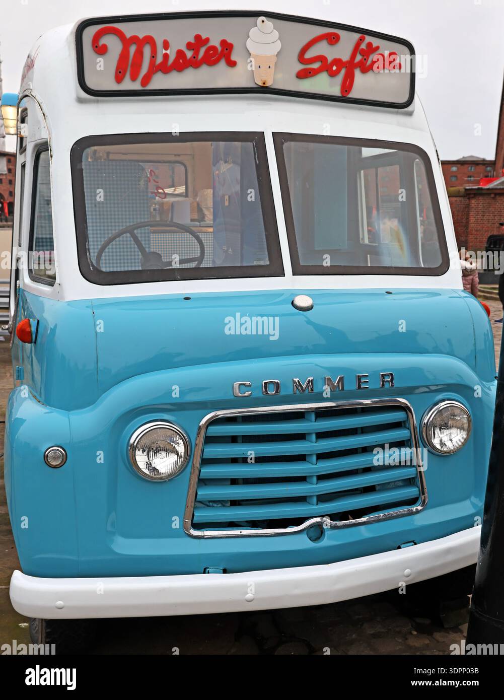 Front view of a vintage Mister Softee ice cream van, a blue and cream Commer vehicle with classic “Mister Softee” roof signage and ice cream cone grap Stock Photo