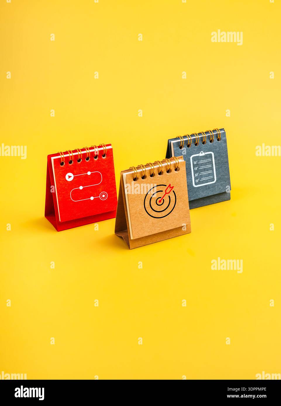 Three desk calendar with icons of checklist, target, and roadmap on ...
