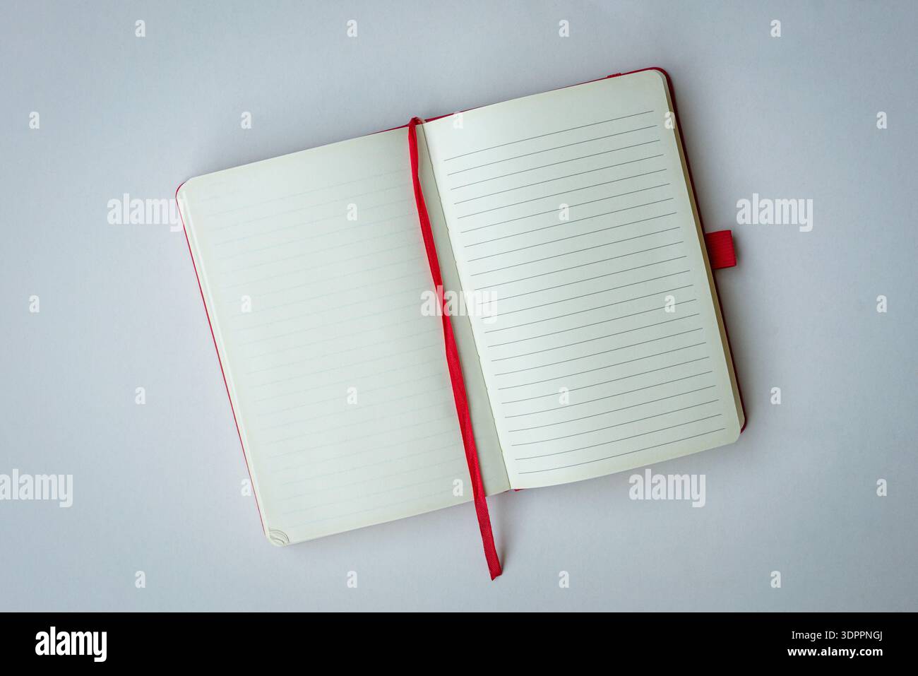 Open notebook with red bookmark. Top view, isolated on white background. Copy space. Stock Photo