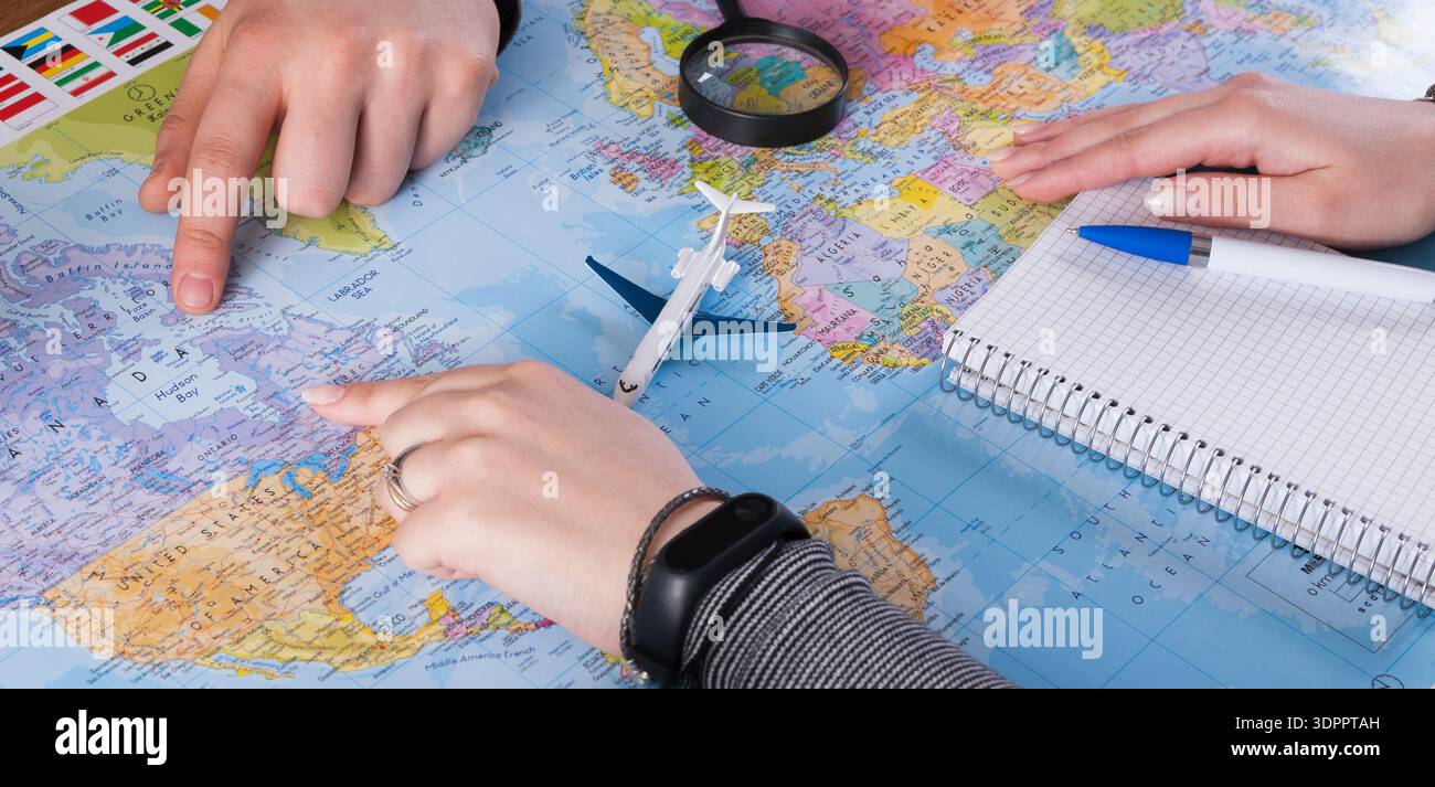 Planning a Trip Using a Map and a Notebook in a Travel Planning Session ...