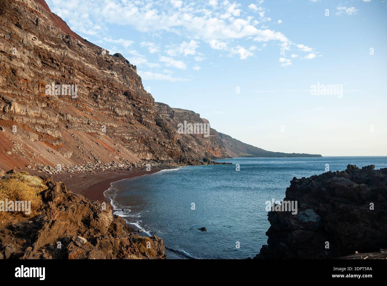 volcanic sand beach, with cliffs of ancient volcanic flows, El Hierro ...