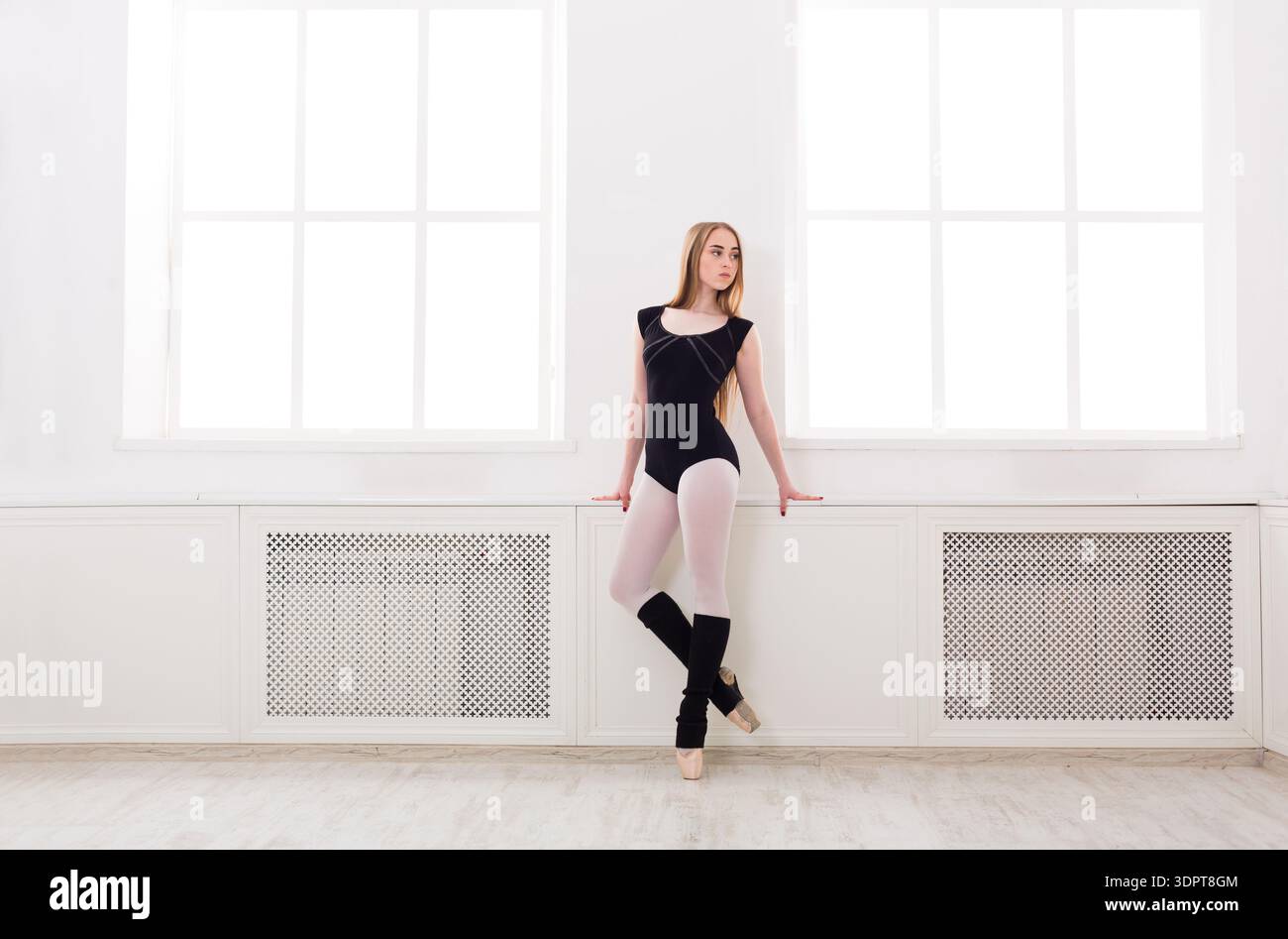 Young Dancer Practices Ballet in a Bright Studio During Daytime Hours Stock Photo