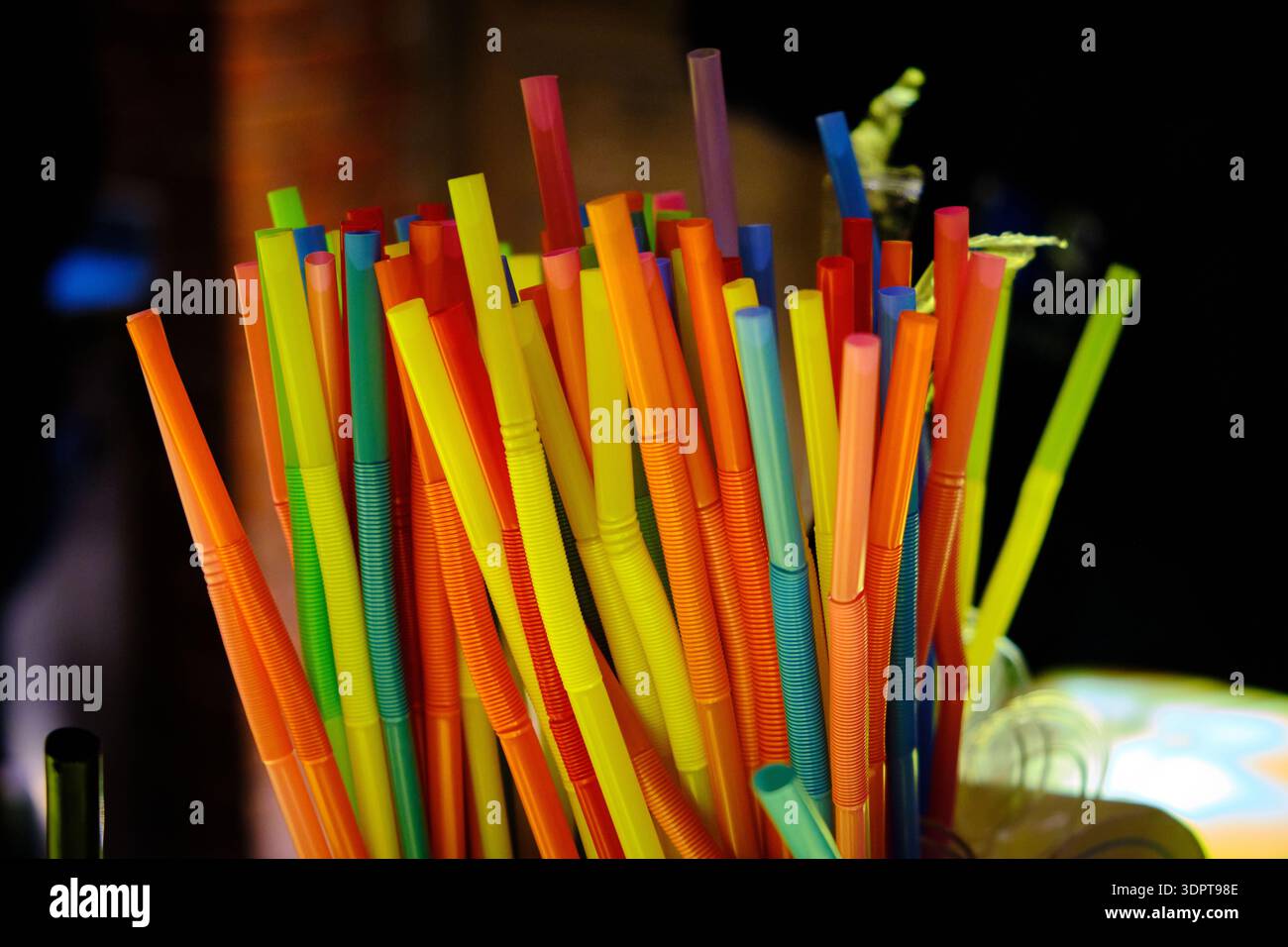 Colorful Plastic Drinking Straws in Bar Setting Stock Photo