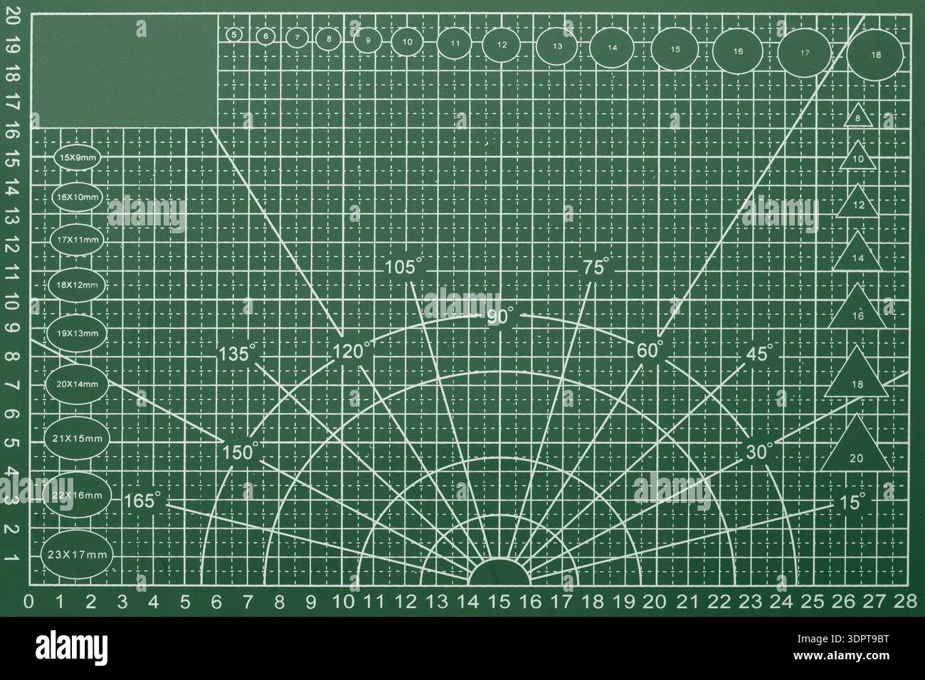 Arts and crafts green cutting mat with grid  lines and dimensions background backdrop. Stock Photo