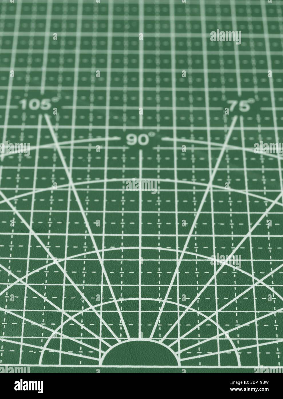 Arts and crafts green cutting mat with grid  lines and dimensions background backdrop. Stock Photo