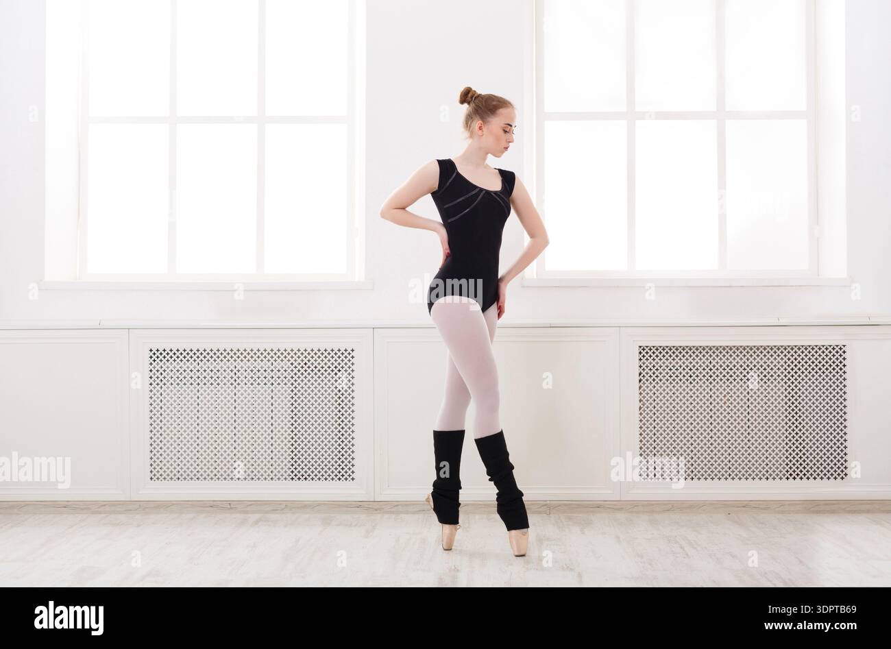 Ballet Dancer Practices in a Bright Studio With Large Windows During the Day Stock Photo
