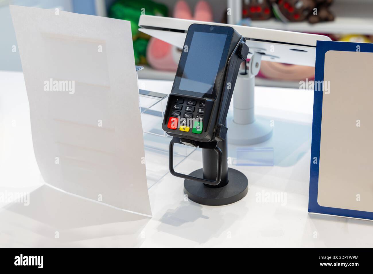 Close-up of an electronic payment terminal at a checkout counter in a ...
