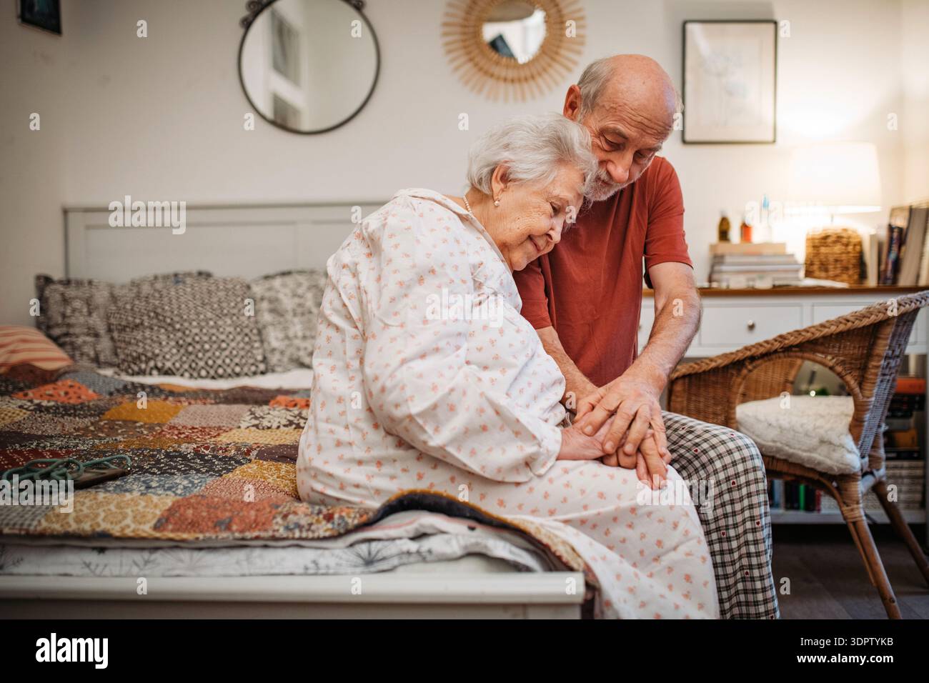 Elderly spouses sharing quiet moment before sleep. Stock Photo