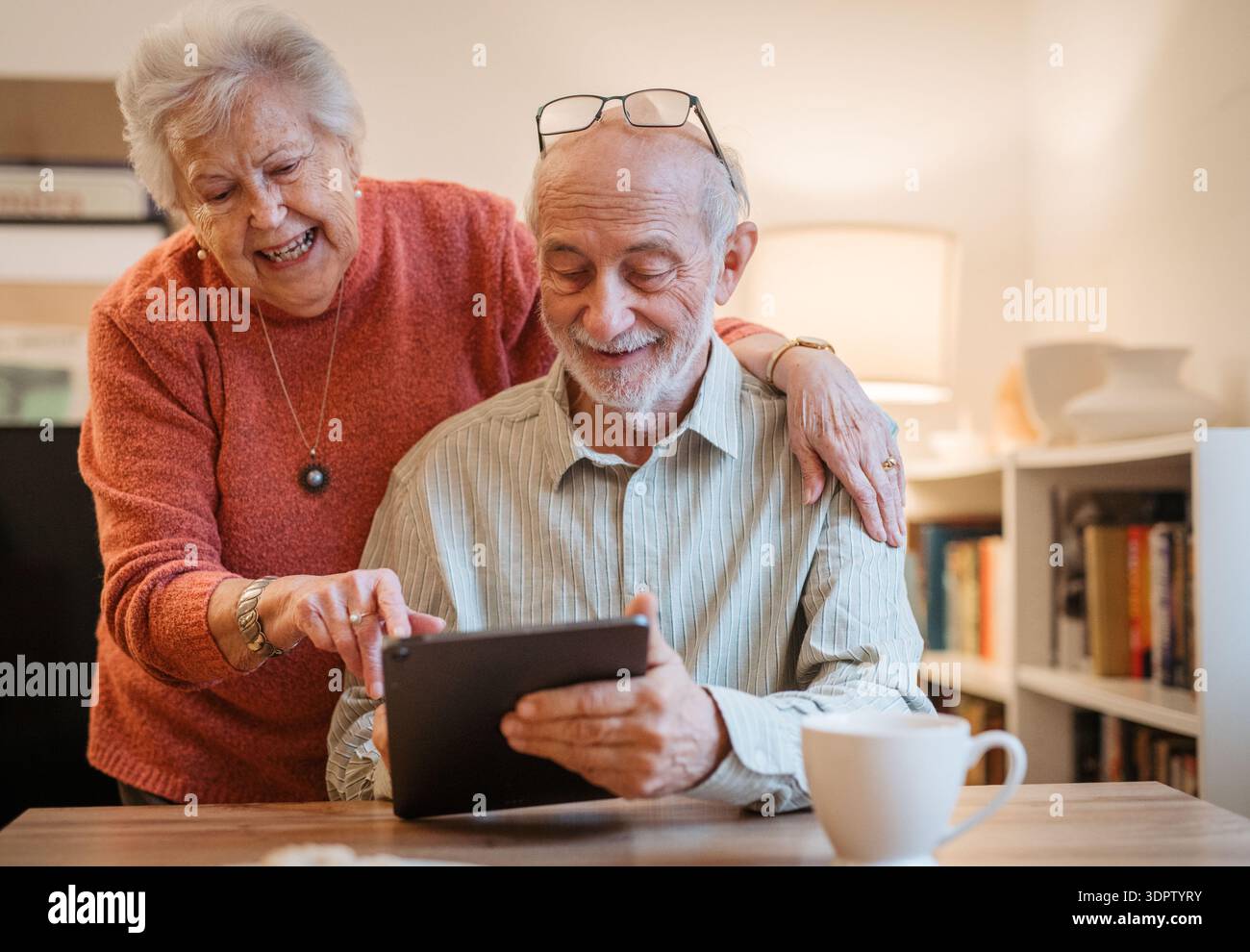 Senior coule working with tablet, having problem with technology. Stock Photo