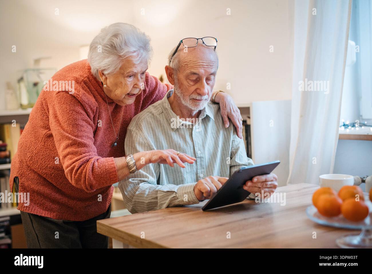 Senior coule working with tablet, having problem with technology. Stock Photo