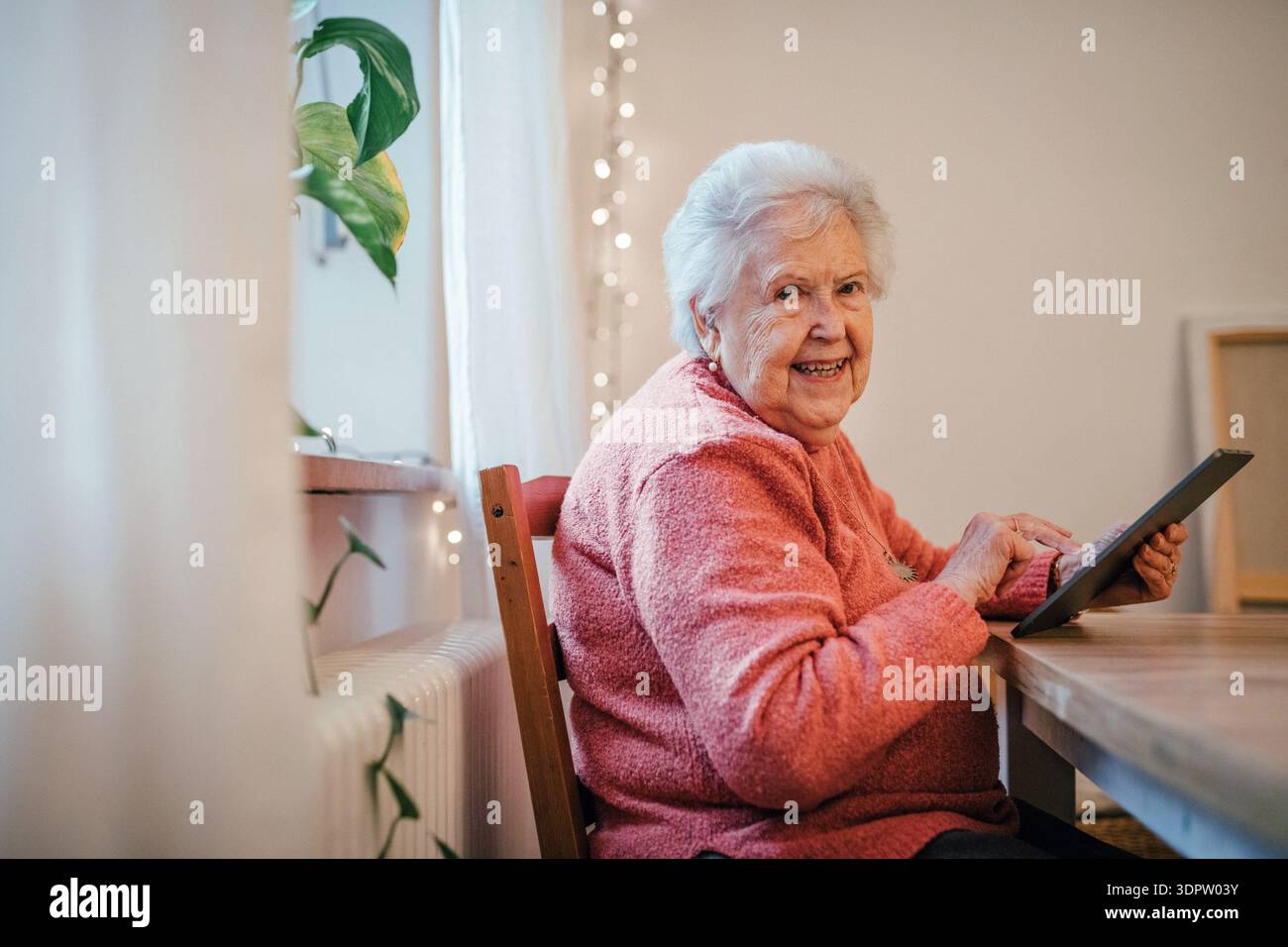 Older woman using tablet, shopping online. Stock Photo