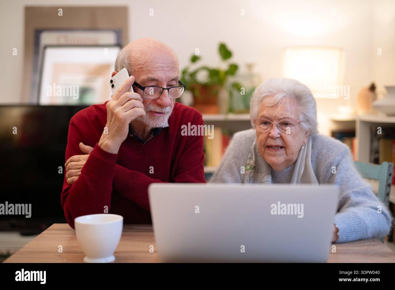 Old people having problem with laptop, calling for help. Stock Photo