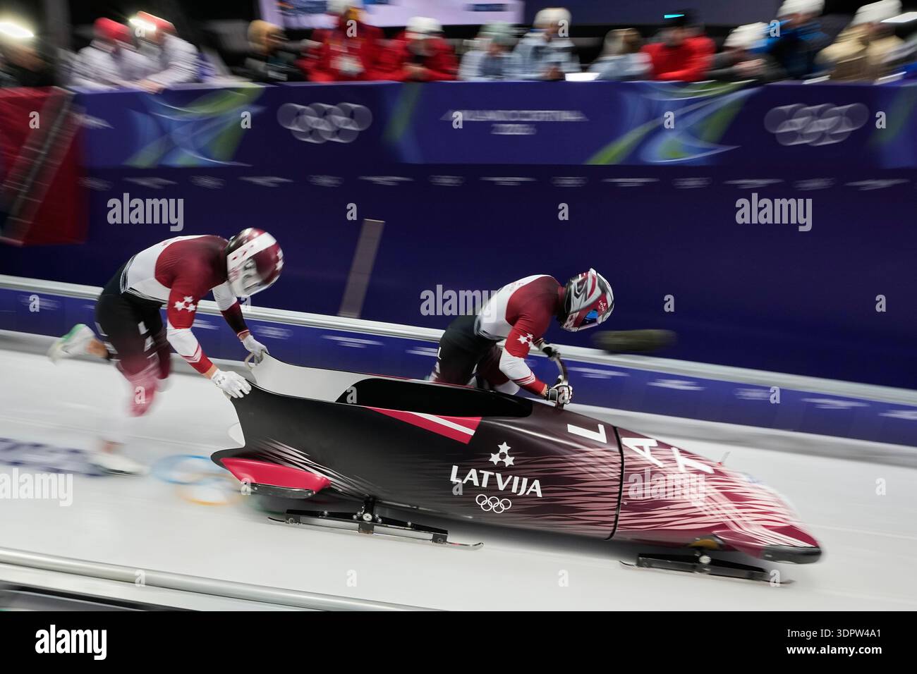 Latvia's Jekabs Kalenda, right, and Matiss Miknis start for a two man ...