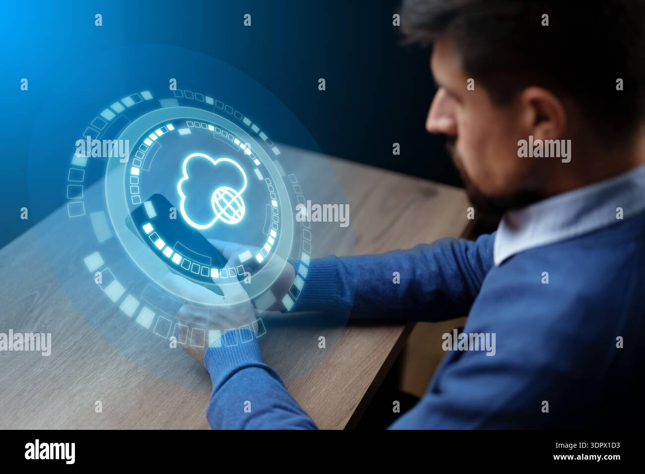 Man interacts with digital cloud interface in office setting during daytime Stock Photo