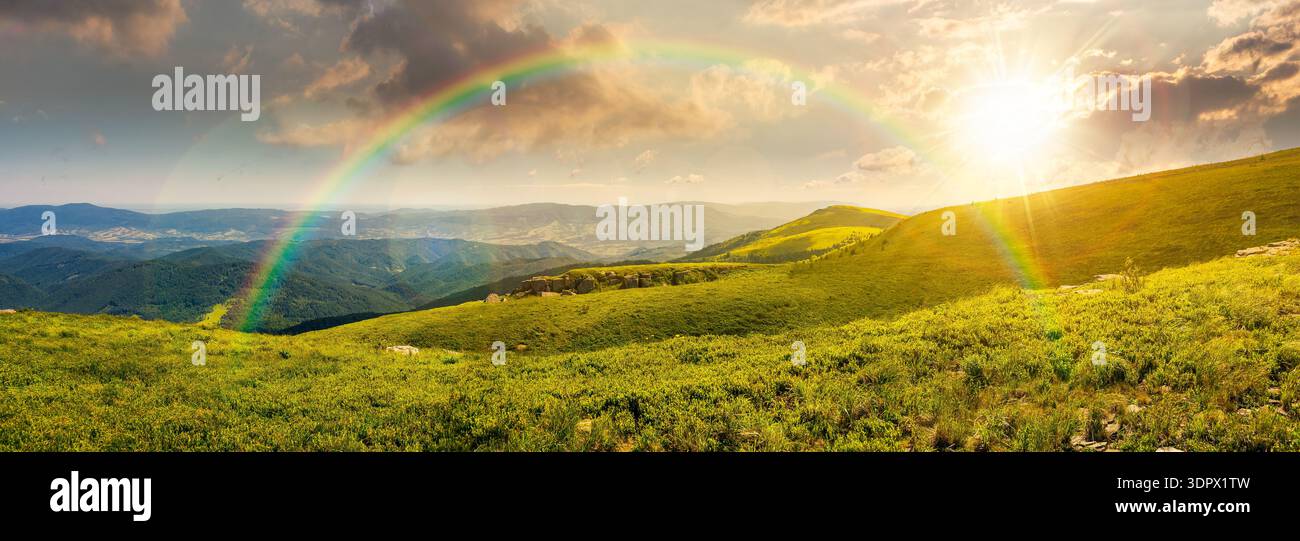 mountainous panorama of rolling hills at sunset. wonderful weather with cloudscape over the distant mountain range in evening light. breathtaking view Stock Photo