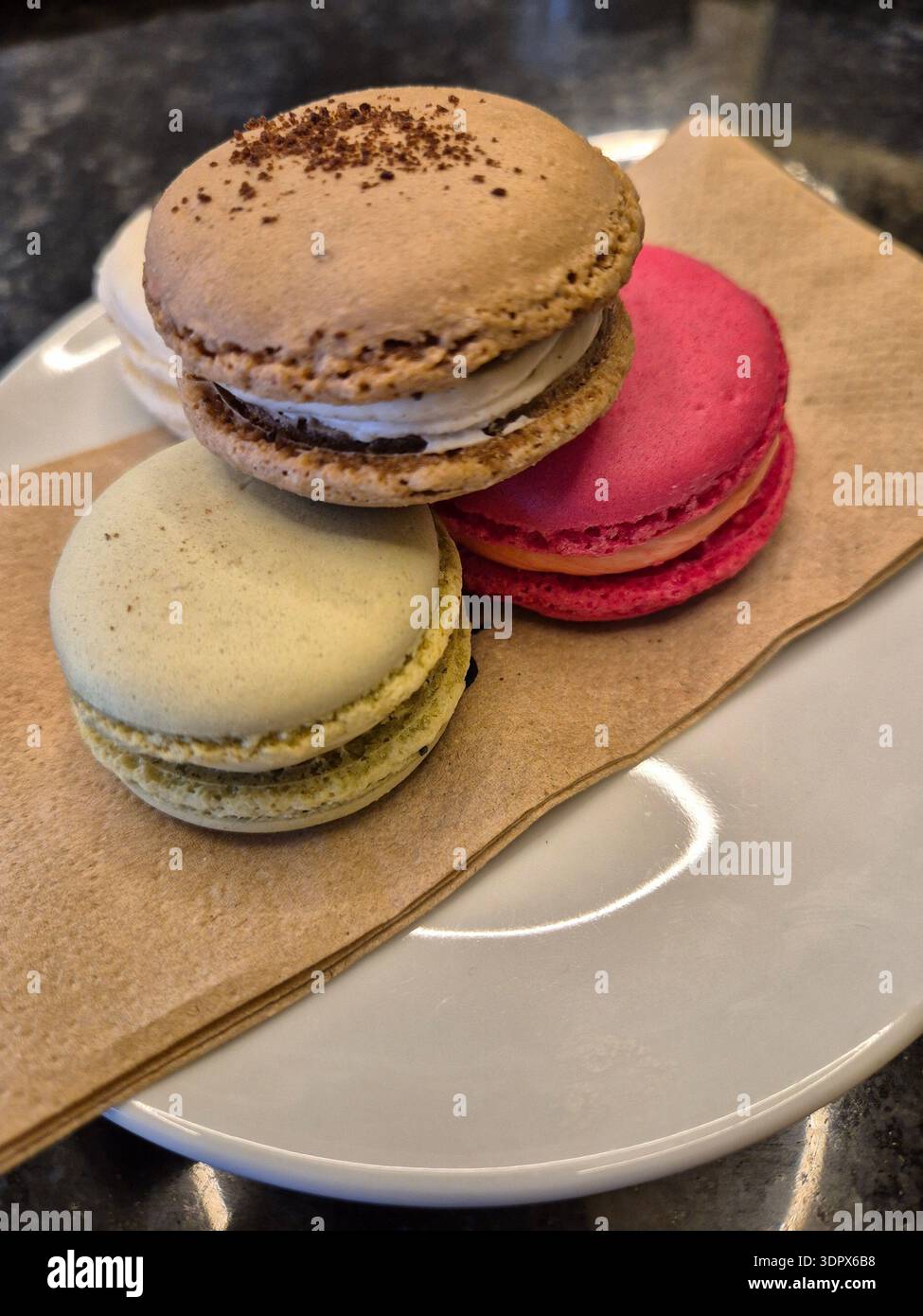 ​Assorted colorful French macarons on a wooden board - Smartphone Captured Stock Image