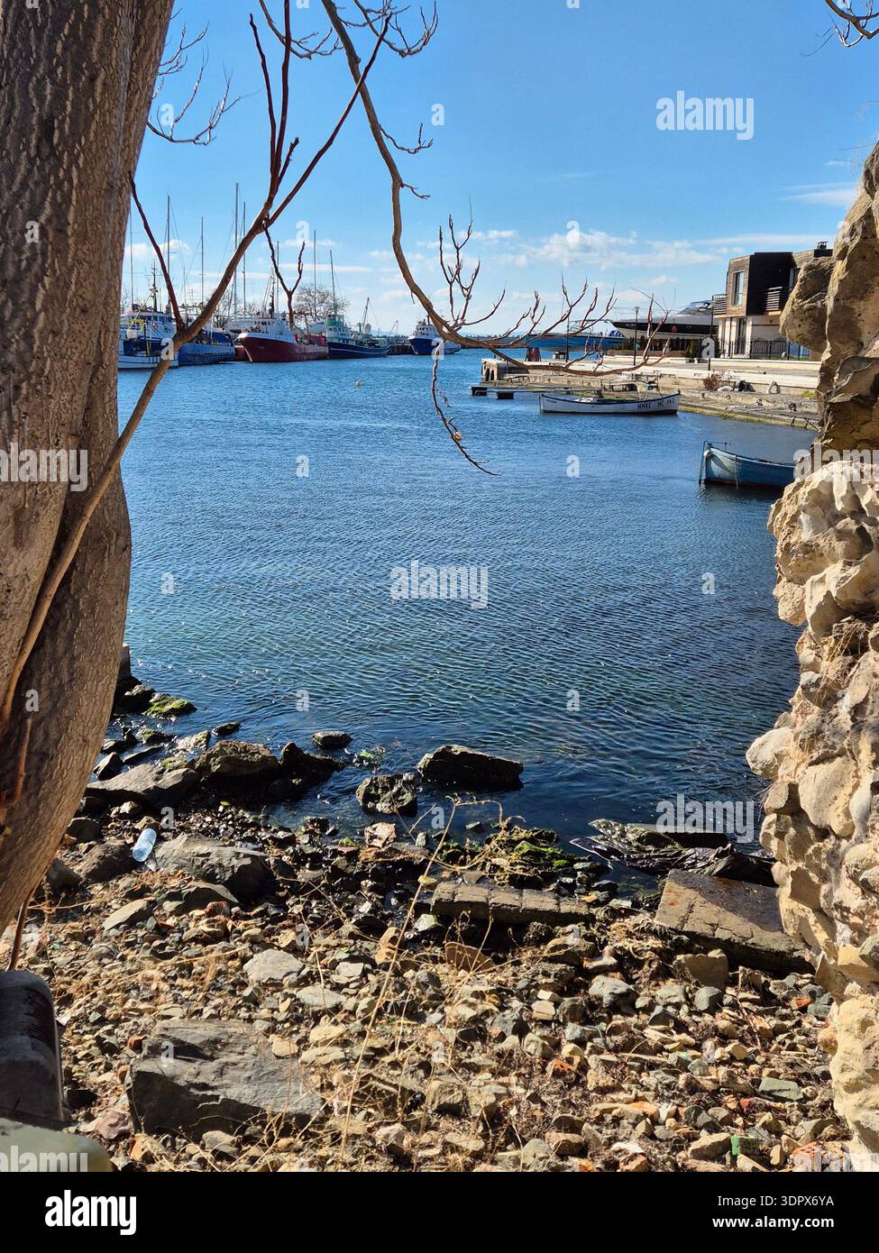Harbor scene with clear blue sky and calm water. - Smartphone Captured Stock Image