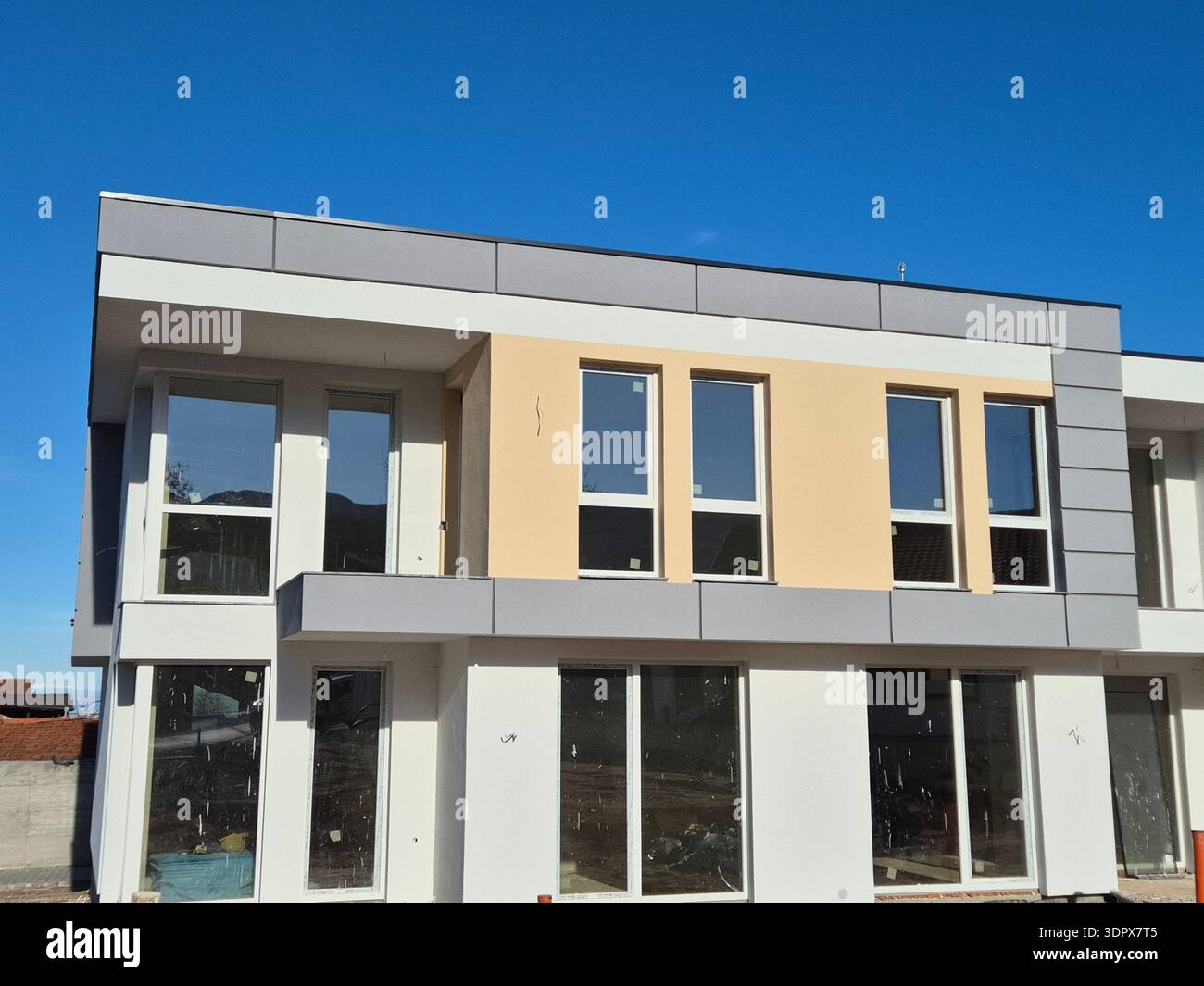 ​Contemporary architectural design of a new building, exterior construction phase - Smartphone Captured Stock Image