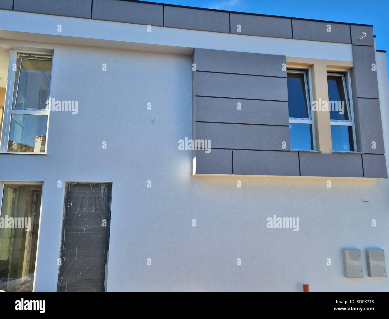 ​Contemporary architectural design of a new building, exterior construction phase - Smartphone Captured Stock Image