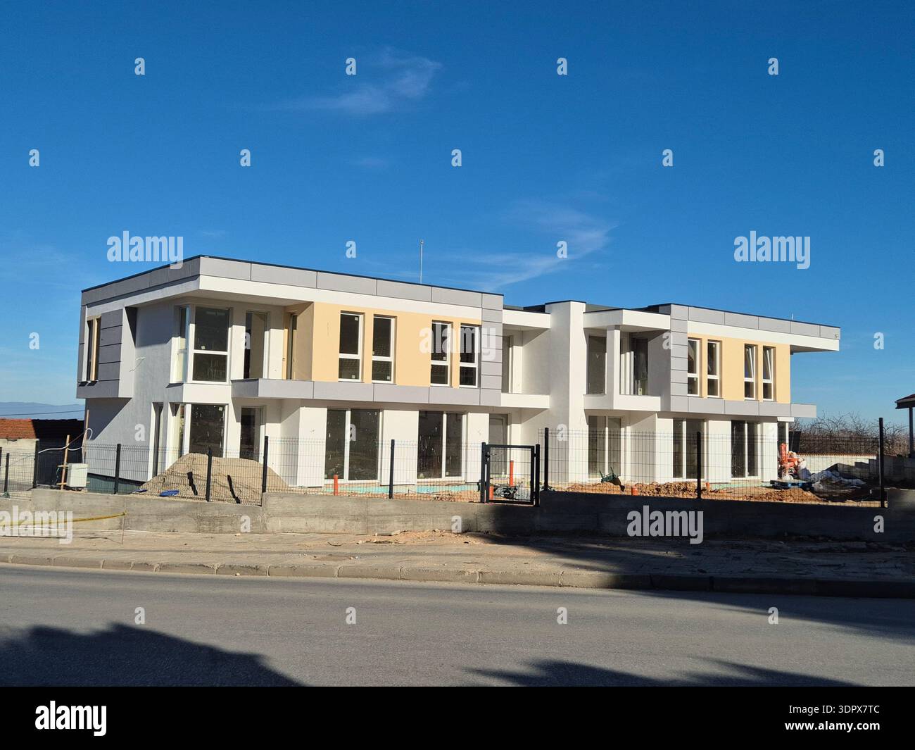 ​Contemporary architectural design of a new building, exterior construction phase - Smartphone Captured Stock Image