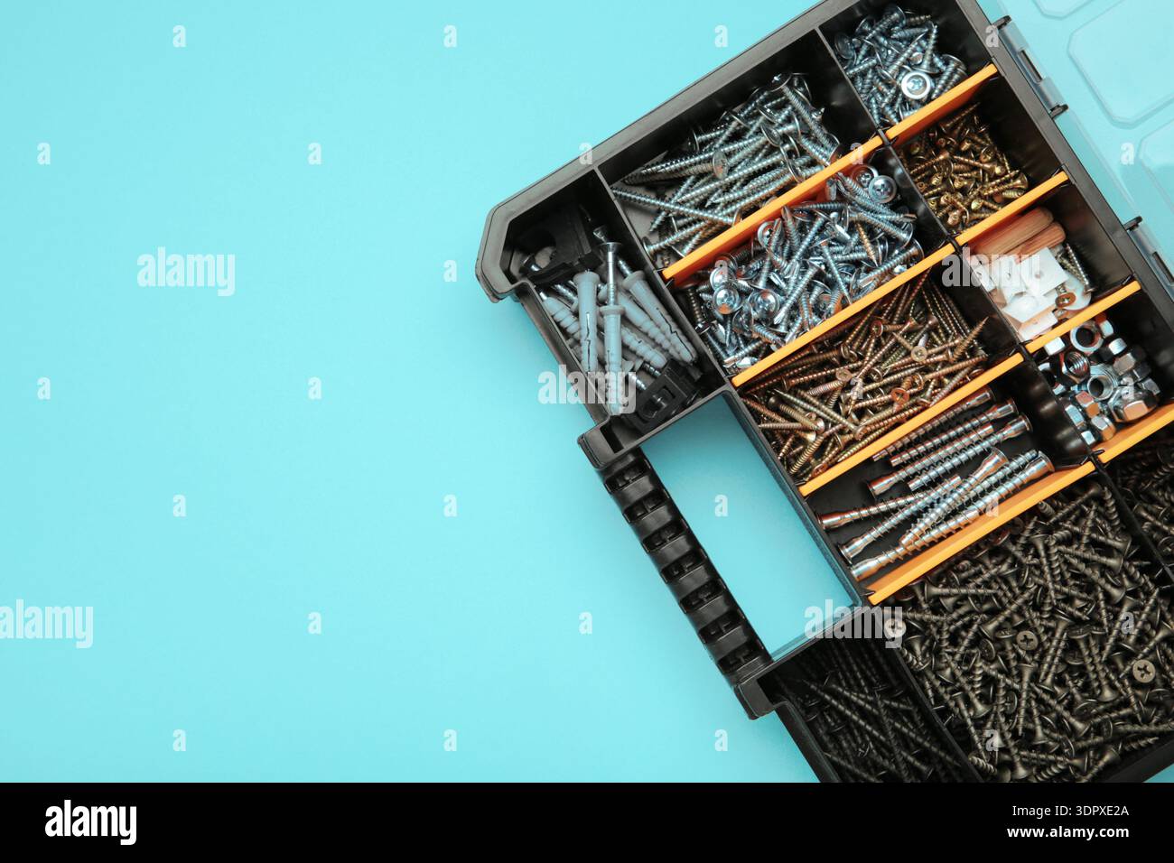 Yellow case with small construction objects on blue background. Space for text Stock Photo