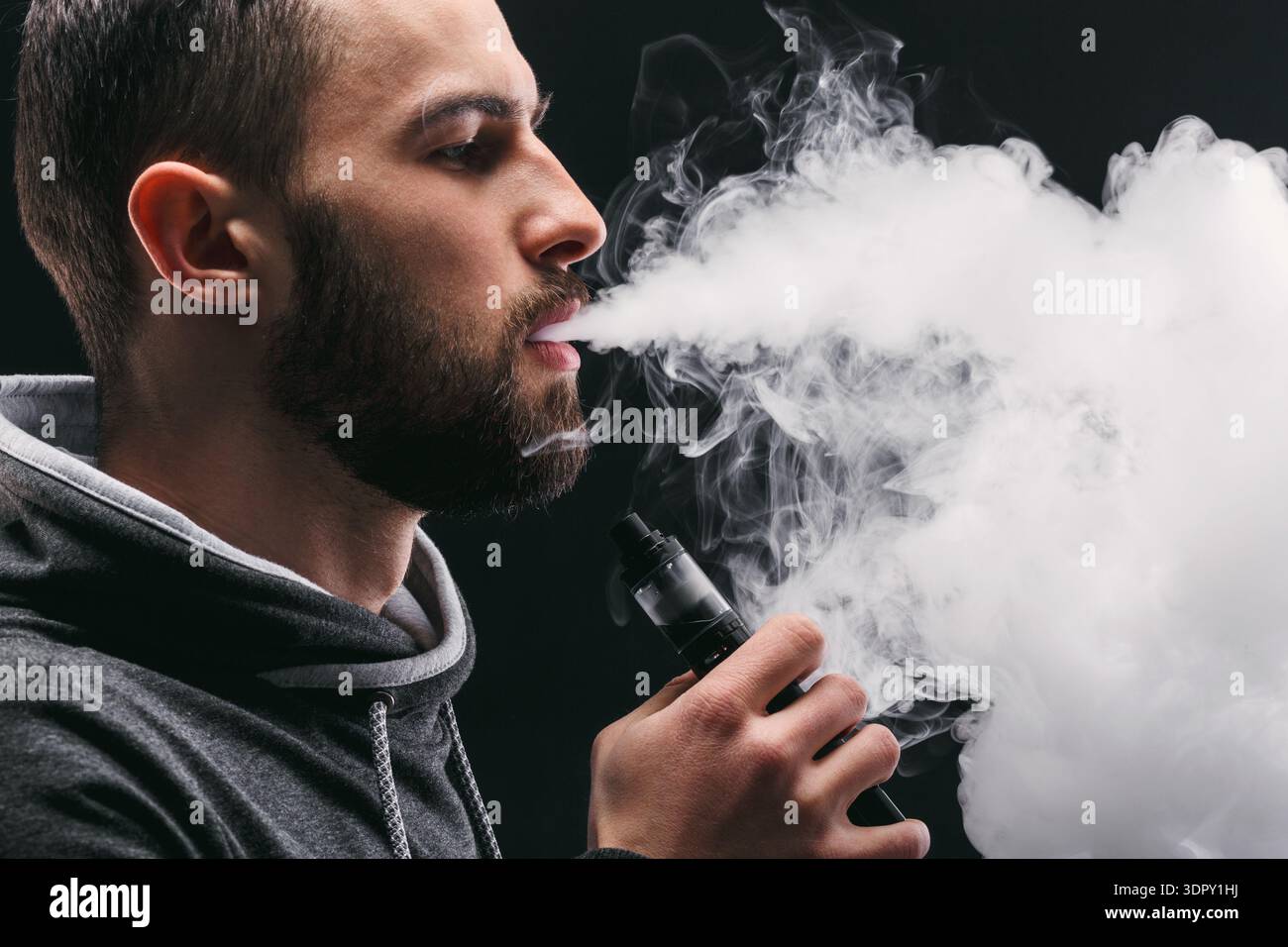 Man Uses Vape Pen and Exhales Large Clouds of Smoke Indoors in a Dark Setting Stock Photo - Alamy Man Uses Vape Pen and Exhales Large Clouds of Smoke Indoors in a Dark Setting Stock Photo - Alamy