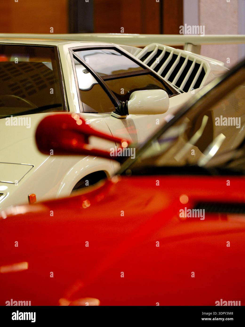 Right Side Mirror of Red Ferrari 512 TR with Blurred White Lamborghini ...