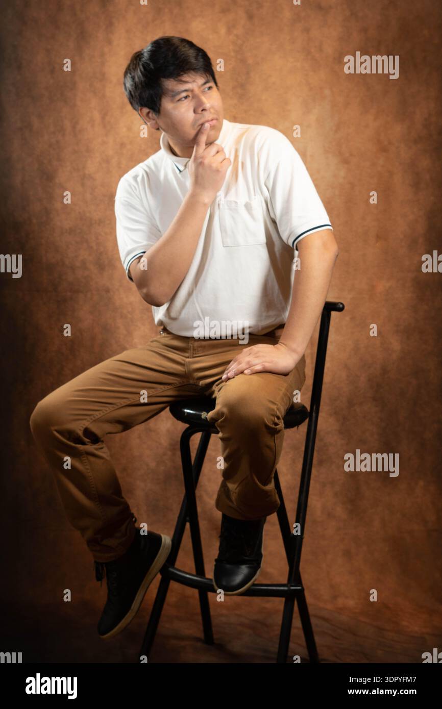 Thoughtful young man in studio Stock Photo