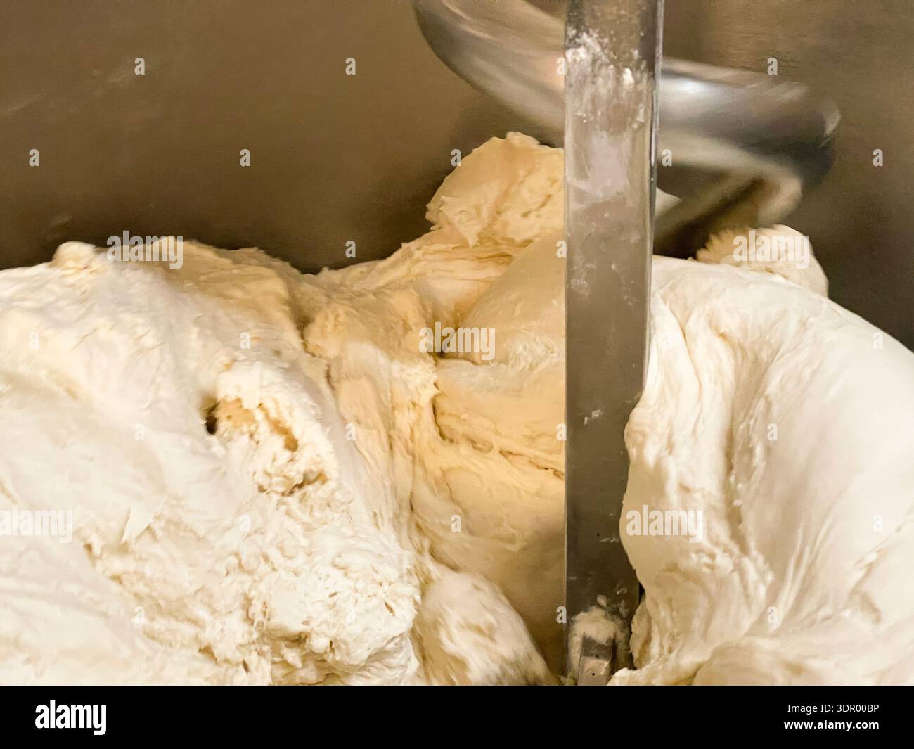 Homemade bread dough balls on a baking tray and dough kneading process in a mixer. - Smartphone Captured Stock Image