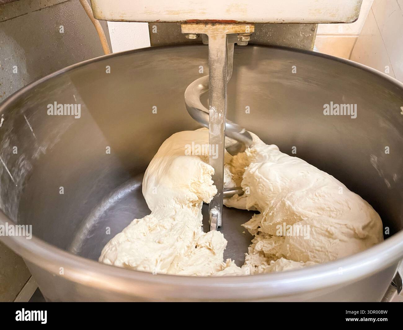 Homemade bread dough balls on a baking tray and dough kneading process in a mixer. - Smartphone Captured Stock Image