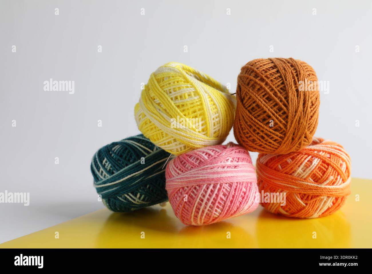 Many different spools of thread on light grey background, closeup Stock Photo