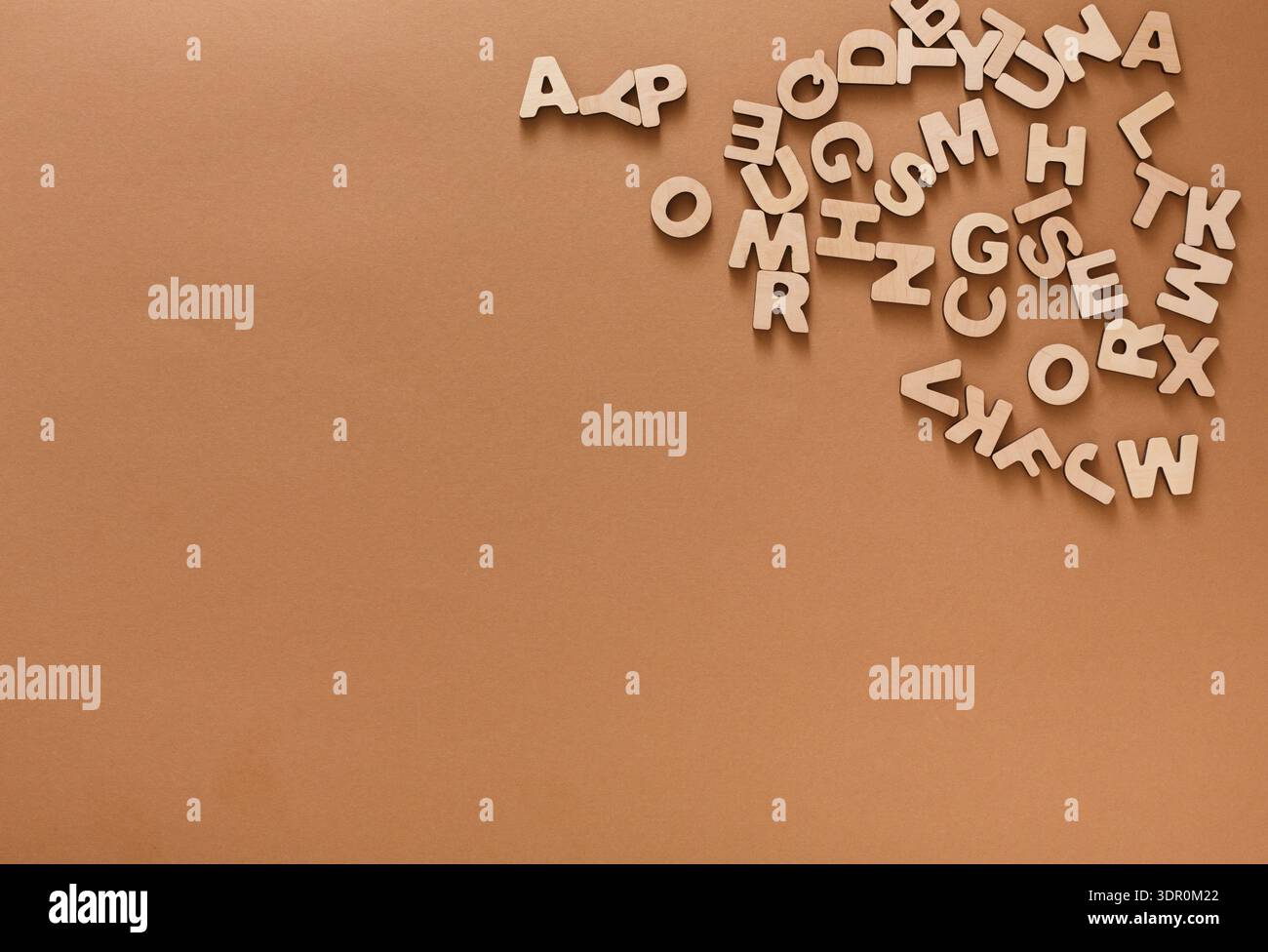 Wooden Letters Scattered on a Brown Surface During a Creative Activity for Learning Stock Photo