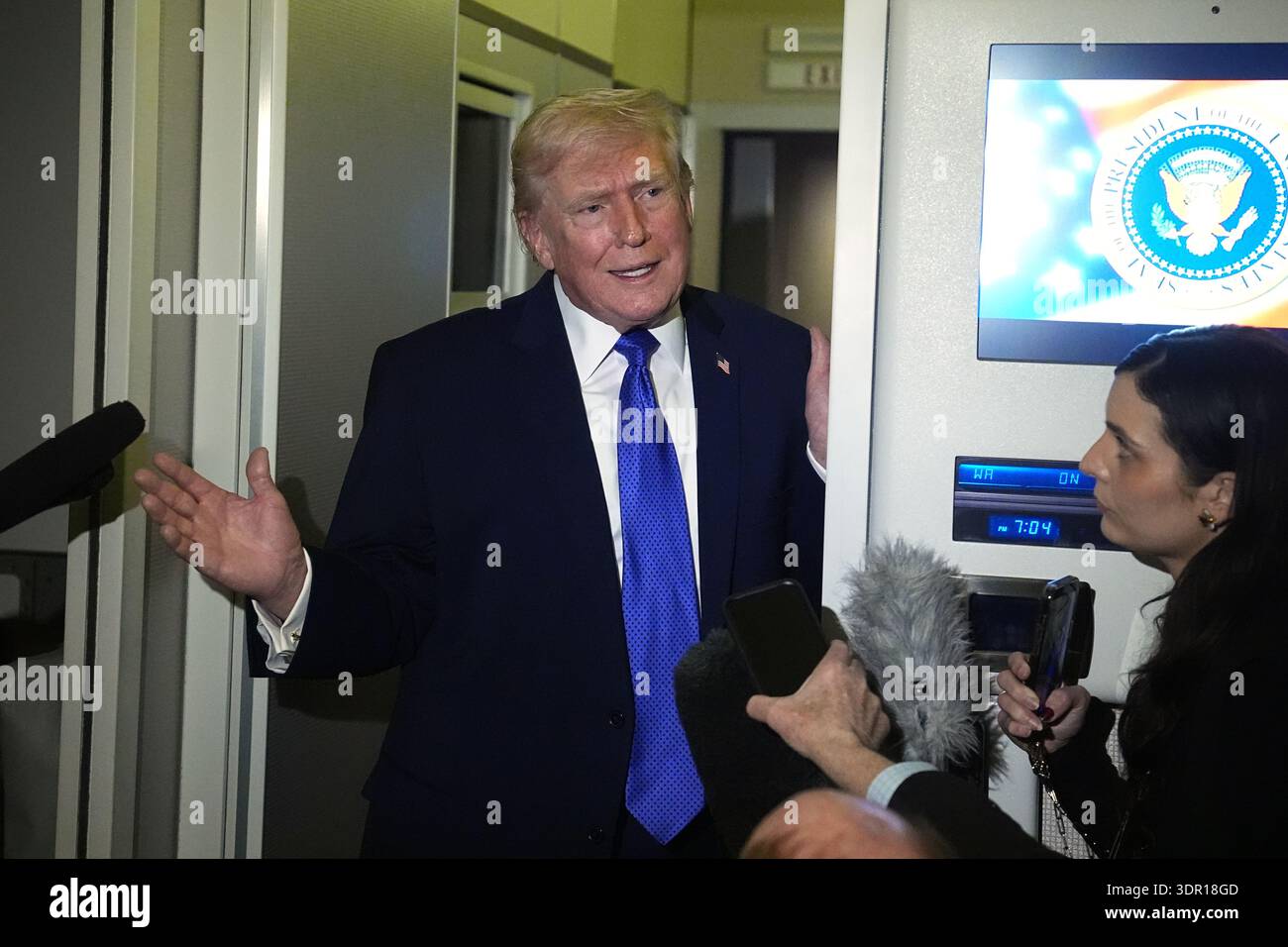 President Donald Trump speaks with reporters aboard Air Force One ...