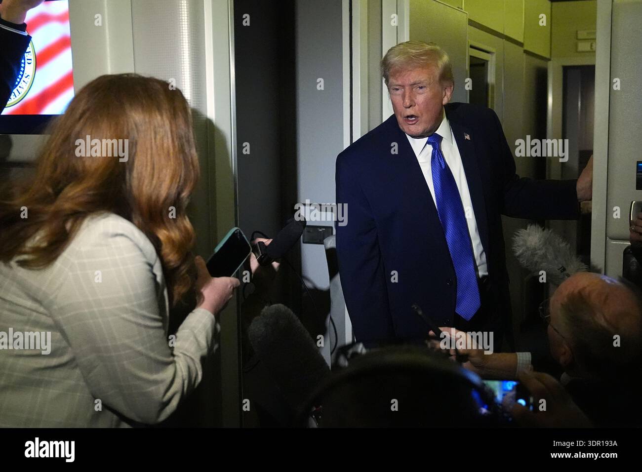 President Donald Trump speaks with reporters aboard Air Force One ...